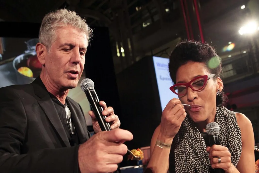 "Hosts Anthony Bourdain and Carla Hall Sample Battling Chefs' Creations at the 2014 Event" by DC Central Kitchen is licensed under CC BY 2.0